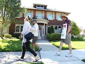 A small group of striking CUPE 1393 members picket Thursday, Sept. 26, 2013, in front of University of Windsor president Alan Wildeman's residence on Sunset Avenue in Windsor, Ont. (DAN JANISSE/The Windsor Star)