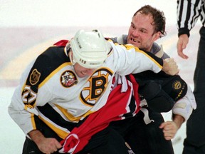 New Jersey Devils defenceman Ken Daneyko, right, fights Boston forward Steve Leach. (AP Photo/Dan Loh, File)
