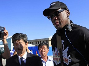 Former NBA star Dennis Rodman arrives at Pyongyang airport, North Korea,  Tuesday, Sept. 3, 2013. Rodman said he plans to hang out with authoritarian leader Kim Jong Un, have a good time and maybe bridge some cultural gaps — but not be a diplomat.  (AP Photo/Jon Chol Jin)