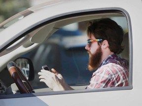 File photo of a man texting and driving. (Windsor Star files)