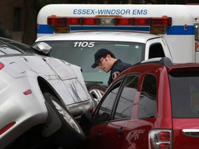 Emergency workers tend to a motor vehicle accident between a Chevy Optra and a Chevy Equinox on the 1300 of Ouellette Ave., Friday, Sept. 13, 2013. (DAX MELMER/The Windsor Star)