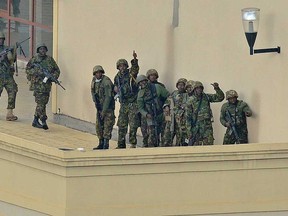 A Kenyan soldier gives the thumbs up signal on September 24, 2013 after clearing the top floor balcony and interior of the Westgate mall in Nairobi. Al-Qaeda-linked Islamist militants, claiming they were still holding hostages, on September 24  battled Kenyan troops for the fourth day of a bloody siege at the mall and threatened further attacks against the country. Sporadic gunfire and a series of explosions at the upmarket Westgate shopping center rang out throughout the day, despite officials earlier claiming Kenyan troops had wrested back "control" of the sprawling complex from Somalia's Shebab insurgents, who are said to include Americans and a British woman. At least 65 shoppers, staff and soldiers have been killed and close to 200 wounded in the siege.   (CARL DE SOUZA/AFP/Getty Images)