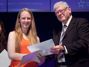 In this handout photo, Meagan Fabel, 17, accepts her award of $4,000 after winning the Young Canadian Award for the 2013 Ernest C. Manning Innovation Awards. The Walkerville high school student who discovered a way to dramatically increase a solar cell's power output was among the winners of a prestigious national science and innovation award announced Monday, Sept. 30, 2013. (Handout)