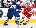 Detroit's Gustav Nyquist, right, is checked by Toronto's John-Michael Liles at the Air Canada Centre. (Photo by Abelimages/Getty Images)
