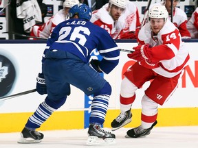 Detroit's Gustav Nyquist, right, is checked by Toronto's John-Michael Liles at the Air Canada Centre. (Photo by Abelimages/Getty Images)