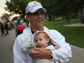 Bill Pillion, a survivor of multiple myeloma, holds his three-month old grandson, Spencer Lanoue, as he walks in the March for Multiple Myeloma at Dieppe Gardens in Windsor, Ont., Sunday, Sept. 29, 2013. (DAX MELMER/The Windsor Star)