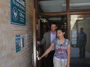 Southwood Public School student Alexandra Lucier and vice-principal Bryan Johnson walk through the newly installed controlled entrance at the South Windsor school on Sept. 5, 2013. (JASON KRYK/The Windsor Star)