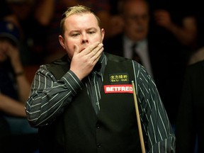 In this April 21, 2011 file photo Stephen Lee plays against John Higgins during their 2nd round match of the World Snooker Championships at the Crucible, Sheffield. Stephen Lee has been banned for 12 years after being found guilty of seven match-fixing charges, World Snooker confirmed Wednesday, Sept 25,2013."The fixing occurred at several top events in the sport, over a sustained period, and is damaging to its reputation,” independent tribunal chairman Adam Lewis said.(AP Photo/PA,Gareth Copley, File)