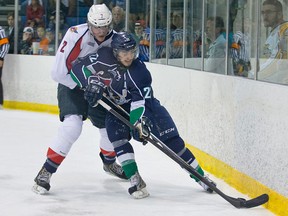 Windsor's Pat Sanvido, left, checks Plymouth's Matt Mistele Saturday in Livonia. (RENA LAVERTY/Plymouth Whalers)