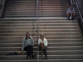 Elderly men sit in a stairwell of a subway station in Taipei, Taiwan, Monday, Sept. 30, 2013. According to its cabinet-level Council for Economic Planning and Development, Taiwan faces an accelerated aging population and declining fertility rate. In more than four years, the elderly population will outnumber the juvenile population, meaning the population over 65 will be about four times the population under 14. (AP Photo/Wally Santana)