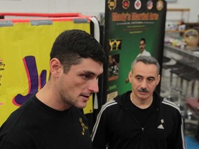 Chris Rogers, 33, of Windsor, Ont., Canadian Forces veteran, 2010 Afghanistan, left, and Albert Mady, owner of Mady's Isshinryu Chikara Dojo, talk about Mady's free membership to veterans. JASON KRYK/The Windsor Star)