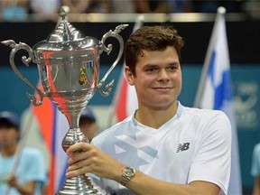 Milos Raonic of Thornhill, Ont., holds up the trophy after his victory over Tomas Berdych of the Czech Republic in the final of the ATP Thailand Open tennis tournament in Bangkok on September 29, 2013. Raonic beat Berdych 7-6, 6-3. (PORNCHAI KITTIWONGSAKUL , AFP/Getty Images)