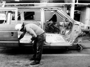 File photo of an autoworker installing a sliding  door on a  new Chrysler minivan in 1983. The first minivan rolled off the line at the  Windsor Assembly Plant Nov. 2, 1983. (Windsor Star files)