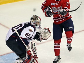 Spitfires goalie Jordan Dekort, left, is screened by Oshawa's Josh Sterk at the WFCU Centre Thursday. (TYLER BROWNBRIDGE/The Windsor Star)