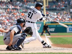 Detroit's Victor Martinez, right, hits a first-inning RBI double in front of Mike Zunino of the Mariners at Comerica Park Thursday. (Photo by Gregory Shamus/Getty Images)