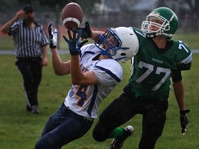 Herman's Aaron Butler, right, battles St. Anne's Alex Bornais during WECSSAA boys football action Friday at Herman. (DAX MELMER/The Windsor Star)