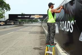 Jason Richards and other crew members work complete the finishing touches for the Detroit Grand Prix in 2013. (TYLER BROWNBRIDGE/The Windsor Star)