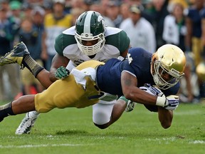 Windsor's Arjen Colquhoun, top, tackles Atkinson III of the Notre Dame Fighting Irish at Notre Dame Stadium Saturday in South Bend, Indiana.  (Photo by Jonathan Daniel/Getty Images)