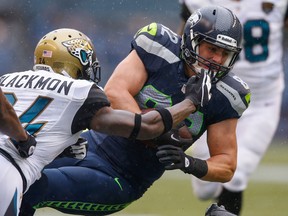 LaSalle's Luke Willson, right, is tackled by Jacksonville cornerback Will Blackmon at CenturyLink Field Sunday in Seattle. (Photo by Otto Greule Jr/Getty Images)
