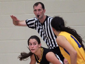 Amherst's Robin Kellam, left, is guarded by St. Anne's Nancy Ulicny in girls basketball. Referee Dan Golding, behind, keeps his eye on the play. (NICK BRANCACCIO/The Windsor Star)