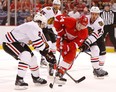 Detroit's Gustav Nyquist, centre, tries to split the Chicago defence of Niklas Hjalmarsson, right, and Duncan Keith at Joe Louis Arena. (Photo by Gregory Shamus/Getty Images)