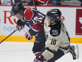 Windsor's Pat Sieloff, right, is checked by Erie's Eric Locke at the  WFCU Centre, (NICK BRANCACCIO/The Windsor Star)