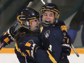 Windsor's Candice Chevalier, left, and Ally Strickland celebrate a goal against Queen's at South Windsor Arena. (DAN JANISSE/The Windsor Star)