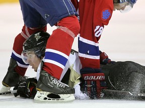 LaSalle's Zack Percy, below, is checked by Strathroy's Andrew Martin at the Vollmer Centre in LaSalle Wednesday. (TYLER BROWNBRIDGE/The Windsor Star)