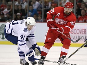Detroit's Henrik Zetterberg, right, is checked by Toronto's Nikolai Kulemin during a pre season game at Joe Louis Arena in 2011. (Photo by Gregory Shamus/Getty Images)