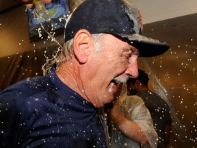 Tigers manager Jim Leyland celebrates with champagne in the clubhouse after the Tigers defeated the Twins 1-0 Wednesday. (Photo by Hannah Foslien/Getty Images)