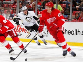 Detroit's Danny DeKeyser, right, looks up ice after getting around James Neal of the Penguins at Joe Louis Arena. (Photo by Gregory Shamus/Getty Images)