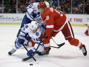 Toronto's Tyler Bozak, left, is tied up with Detroit's Joakim Andersson Friday in Detroit. (AP Photo/Carlos Osorio)