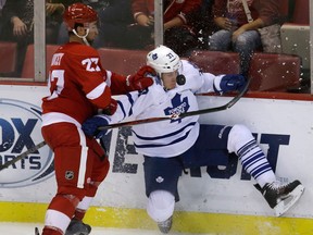 Detroit's Kyle Quincey, left, checks Toronto's Carter Ashton Friday in Detroit. (AP Photo/Carlos Osorio)