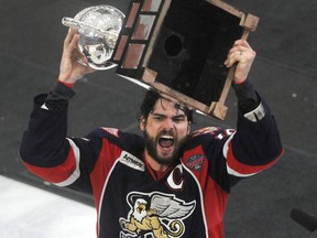 Grand Rapids captain Jeff Hoggan holds up the Calder Cup after the Griffins defeated the Syracuse Crunch 5-2 in Game 6 of the Calder Cup last year in Syracuse, N.Y. (AP Photo/The Syracuse Newspapers, Mike Greenlar)