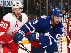 Toronto's Nazem Kadri, right, checks Detroit's Drew Miller Saturday in Toronto, (Photo by Abelimages/Getty Images)