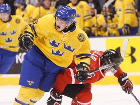 Wings prospect Calle Jarnkrok, left, is checked by ex-Spit Ryan Ellis during a game between Team Canada and Sweden at the Air Canada Centre. (Aaron Lynett/National Post)