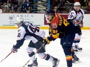 Windsor's Ryan Moore, left, is checked by Erie's Andre Burakovsky at the WFCU Centre Saturday. (JOEL BOYCE/The Windsor Star)