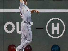 Detroit's Andy Dirks catches a fly ball at the wall against the Boston Red Sox at Fenway Park Wednesday. (Photo by Jared Wickerham/Getty Images)