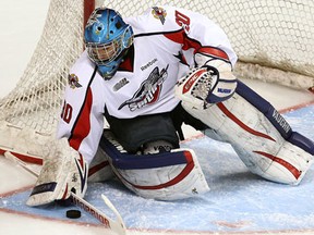 Windsor goalie Dalen Kuchmey makes a save against the Sarnia Sting at the WFCU Centre Friday. (TYLER BROWNBRIDGE/The Windsor Star)