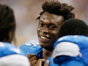 Detroit rookie Ezekiel Ansah, centre, talks on the sideline during pre-season action against New England at Ford Field on August 22, 2013 in Detroit. The Lions open against the Vikings Sunday at Ford Field (1 p.m., Fox). (Gregory Shamus/Getty Images)