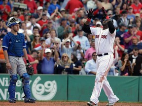 Boston David Ortiz, right, celebrates his home run off a pitch by Toronto Blue Jays' R.A. Dickey as Toronto's Josh Thole, left, looks on in the sixth inning at Fenway Park, in Boston, Sunday, Sept. 22, 2013. (AP Photo/Steven Senne)