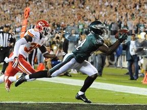 Philadelphia's Jason Avante, right, catches a touchdown pass against Kansas City's Husain Abdullah during NFL action in Philadelphia on Thursday, Sept. 19, 2013. (AP Photo/Philadelphia Daily News, Clem Murray)