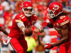 Kansas City QB Alex Smith, left, hands off to Jamaal Charles against Dallas last week. The Chiefs face the Eagles in Philadelphia to kick off Week 3 Thursday night. (Kyle Rivas/Getty Images)