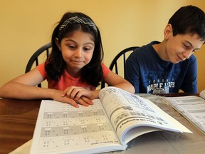 Students Melodi and Oguzhan (right) Yilmaz study at their home in Windsor on Monday, September 16, 2013. Both Melodi and Oguzhan were in split grade classes at the start of the school year.           (TYLER BROWNBRIDGE/The Windsor Star)