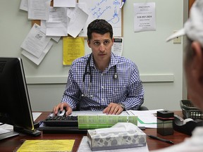 Dr. Peter Farago meets with a patient, Tuesday, Aug. 13, 2013, at his Windsor, Ont. office.  (DAN JANISSE/The Windsor Star)