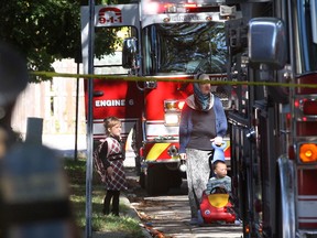 Windsor firefighters responded to a house fire Monday, Sept. 16, 2013, on Endfield Pl. in the Villages of Riverside in Windsor, Ont. The fire started at approximately 4:00 p.m. A woman and two young children check out the scene.  (DAN JANISSE/The Windsor Star)
