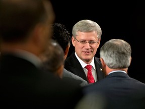 Prime Minister Stephen Harper greets guests at an announcement of new child exploitation legislation in Toronto on  August 29, 2013. (THE CANADIAN PRESS/Frank Gunn)
