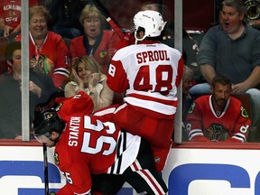 Chicago's Ryan Stanton, left, hip checks Detroit's Ryan Sproul during an exhibition game at United Center on September 17, 2013 in Chicago. The Blackhawks defeated the Red Wings 2-0. (Jonathan Daniel/Getty Images)