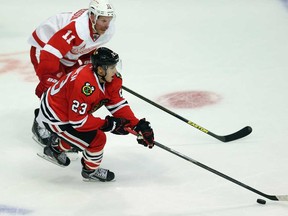 In this file photo, Teuvo Teravainen, front, of the Chicago Blackhawks moves up the ice under pressure from Daniel Alfredsson of the Detroit Red Wings during an exhibition game at United Center on September 17, 2013 in Chicago. (Jonathan Daniel/Getty Images)