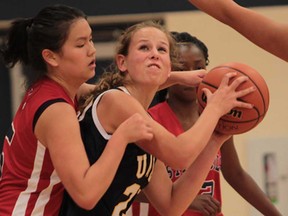 Ste. Cecile's Avien Wang  left, and UMEI's Kiana Epp battle for the ball during WECSSAA senior girls basketball action at St. Cecile on September 23, 2013.  (JASON KRYK/The Windsor Star)